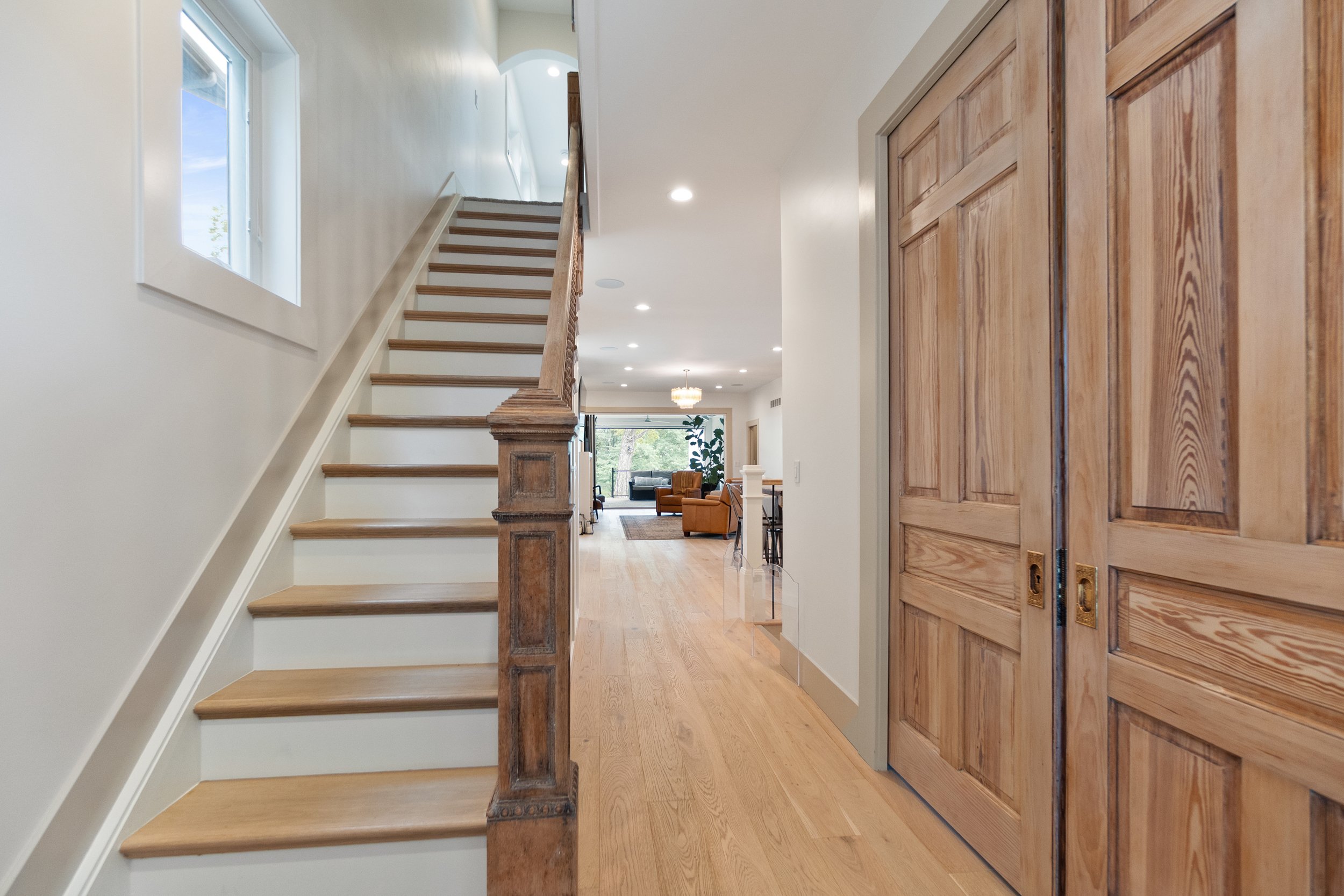 Historic staircase and original pocket doors restored in Fort Thomas Kentucky remodel by Shade Tree Homes