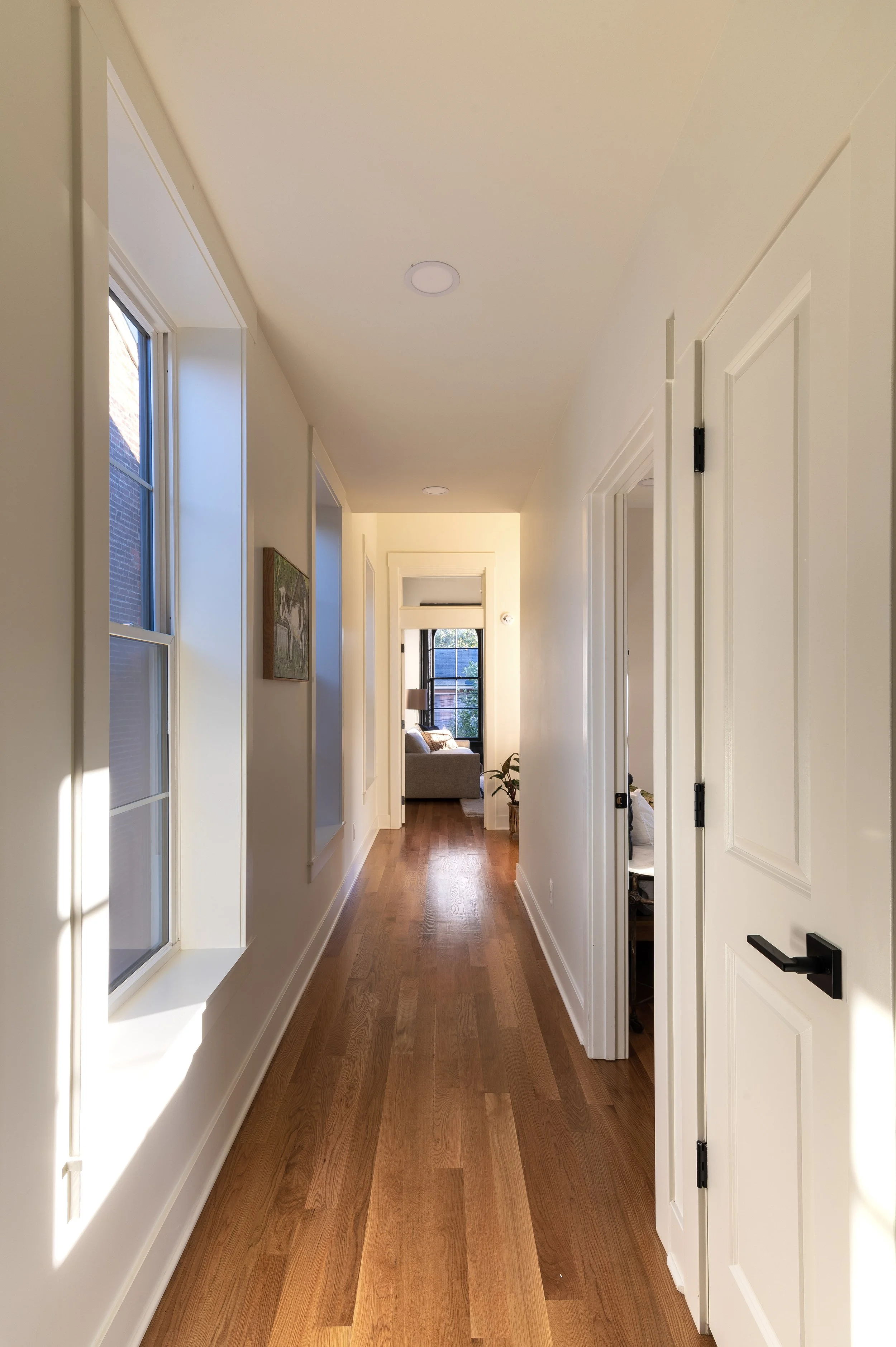 Restored hallway with hardwood floors in Covington Kentucky historic home by Shade Tree Homes