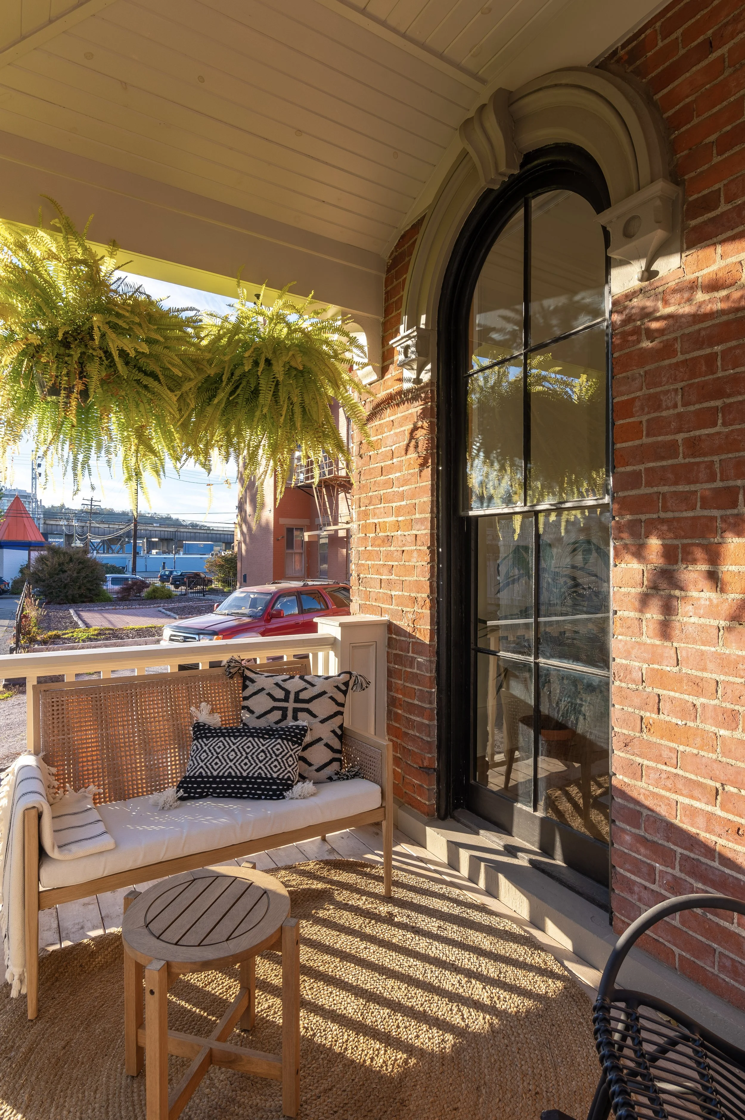 Outdoor living space with historic brick and lush greenery in Covington Kentucky by Shade Tree Homes