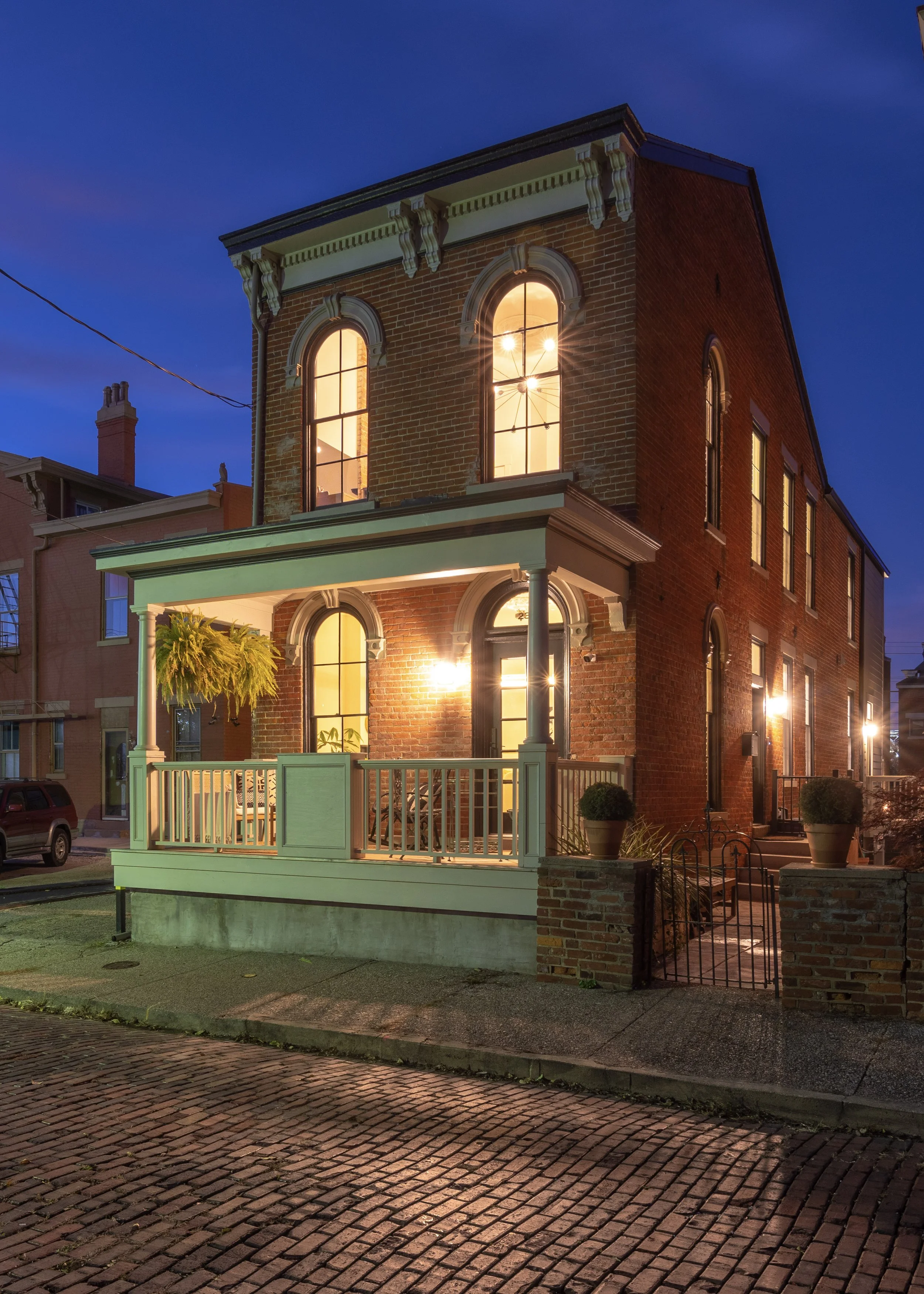 Historic Covington Kentucky home exterior at dusk after full remodel by Shade Tree Homes