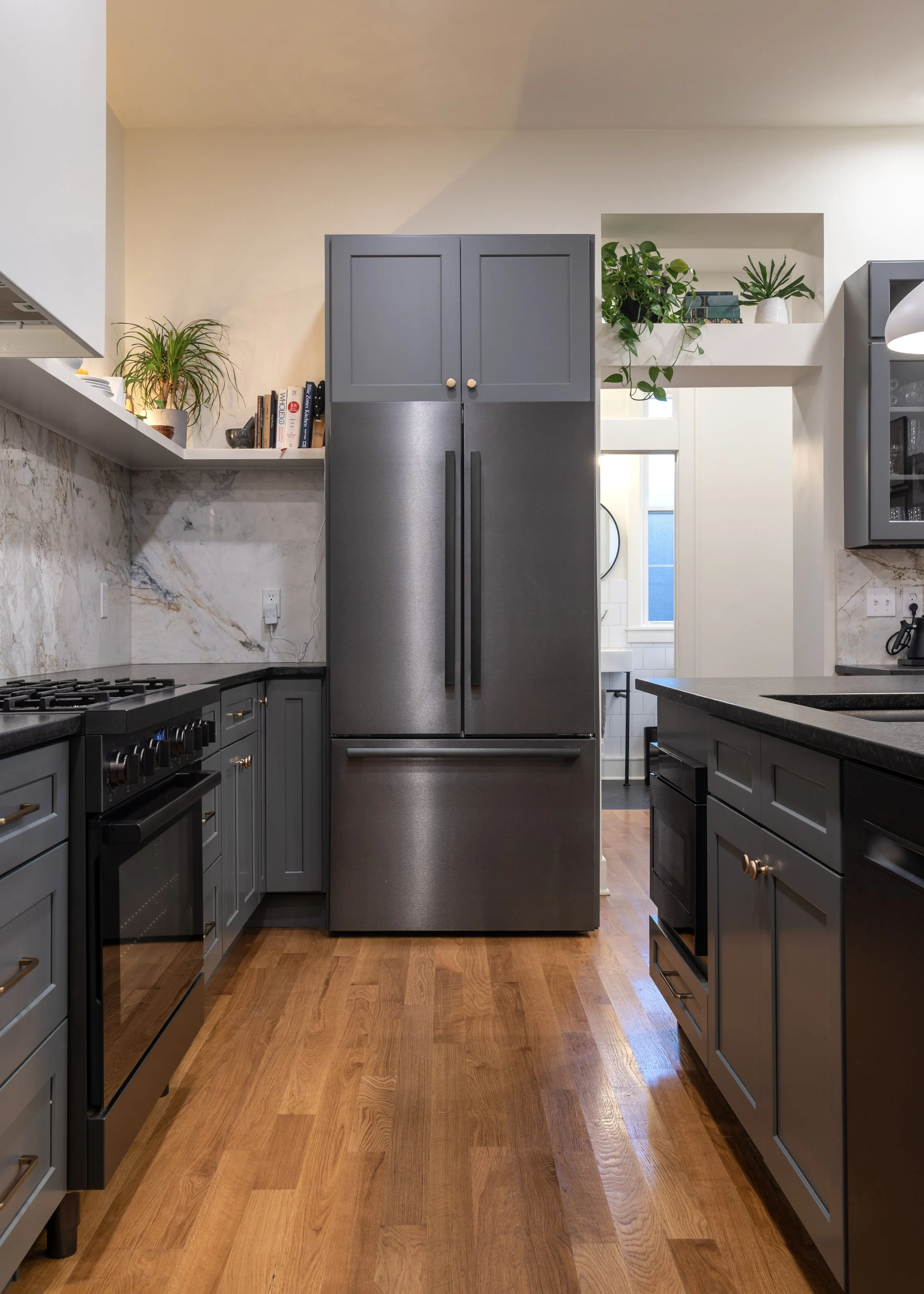 Custom cabinetry and integrated refrigerator column in Covington Kentucky remodel by Shade Tree Homes