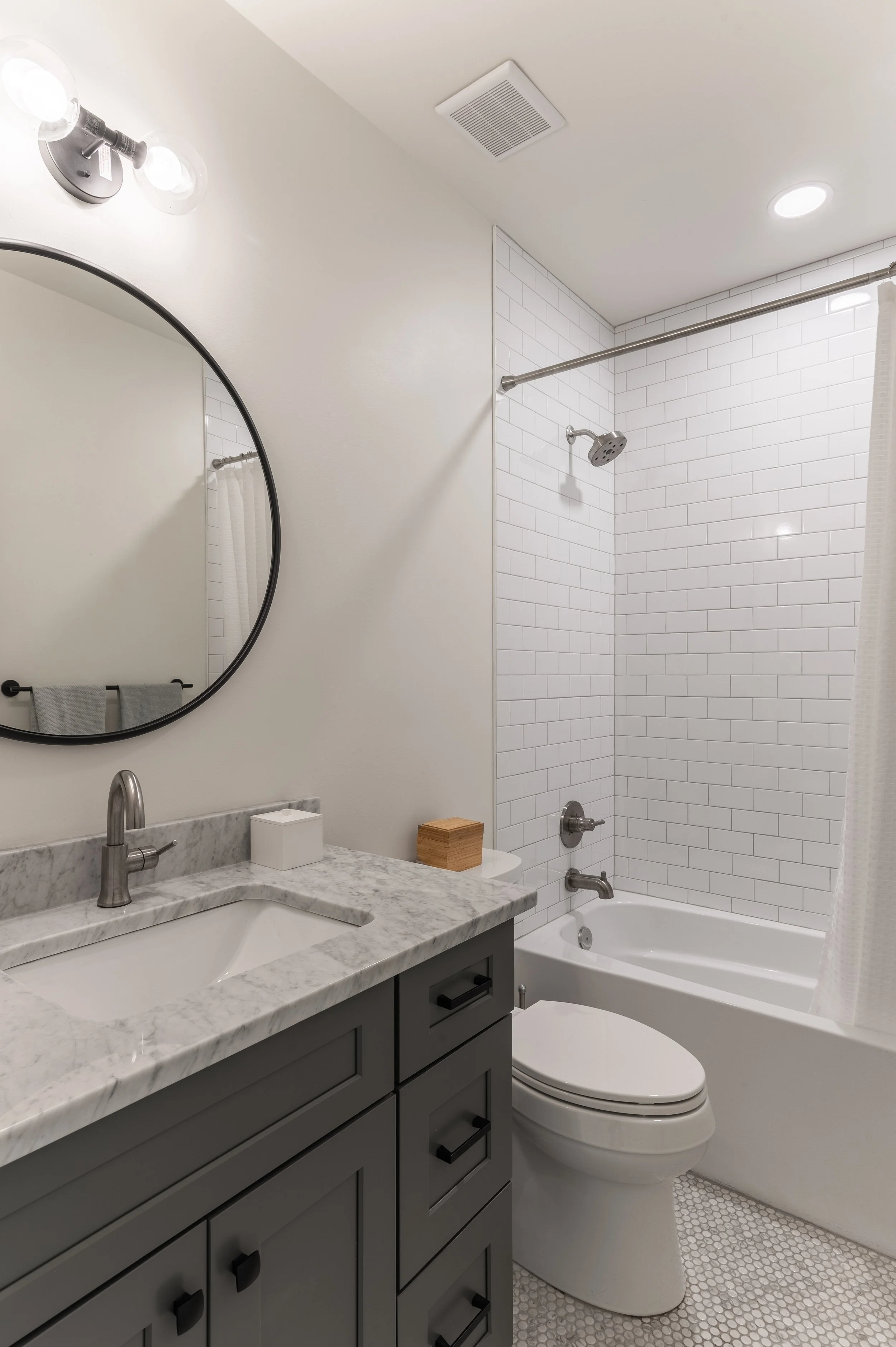 Hall bathroom with tub shower combination in historic Covington Kentucky remodel by Shade Tree Homes