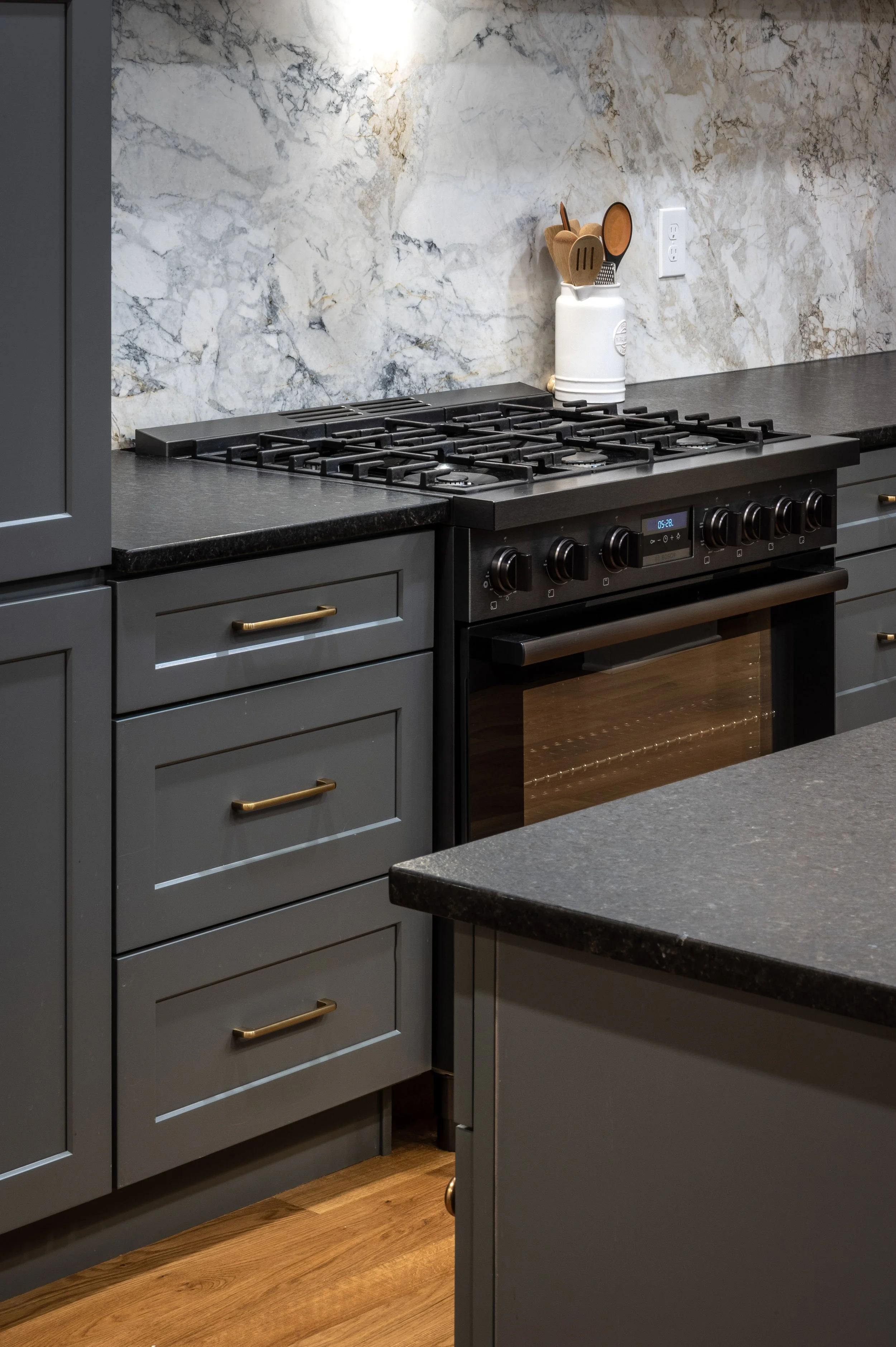 Professional range with custom dark cabinetry in historic Covington Kentucky kitchen by Shade Tree Homes