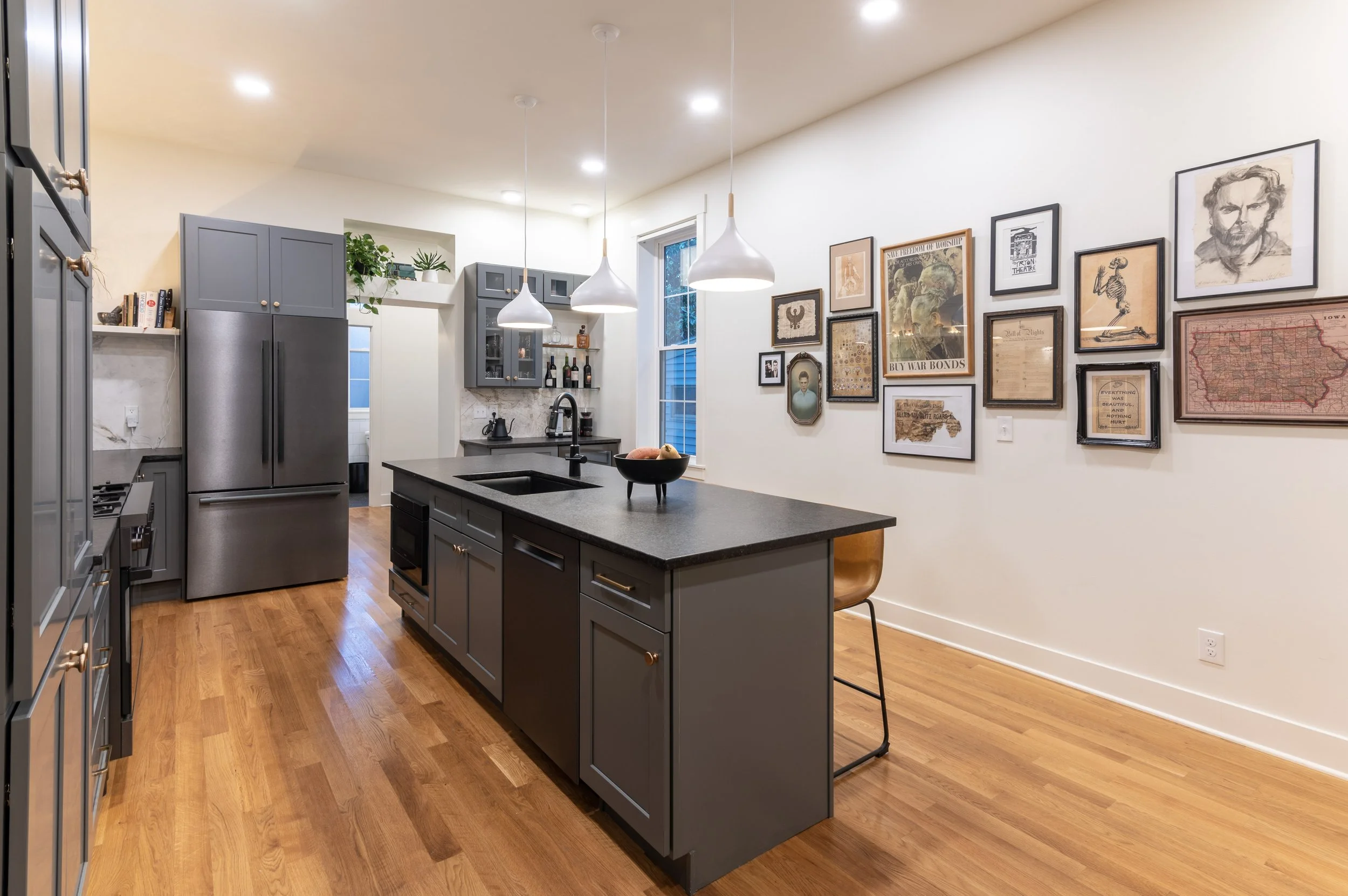 Full kitchen view with gallery wall in historic Covington Kentucky home remodel by Shade Tree Homes