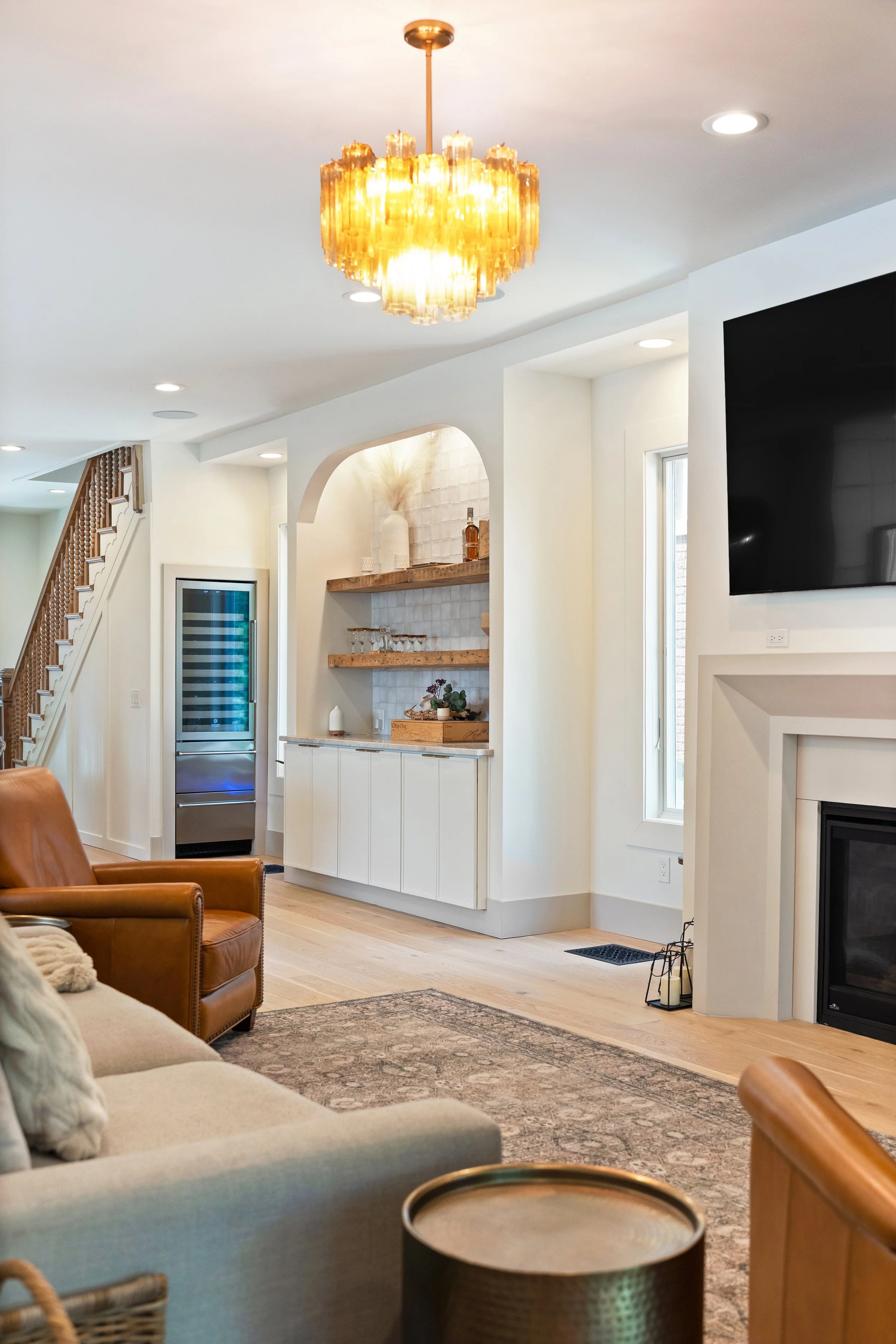 Remodeled living room featuring custom bar and high-end finishes in Fort Thomas Kentucky by Shade Tree Homes