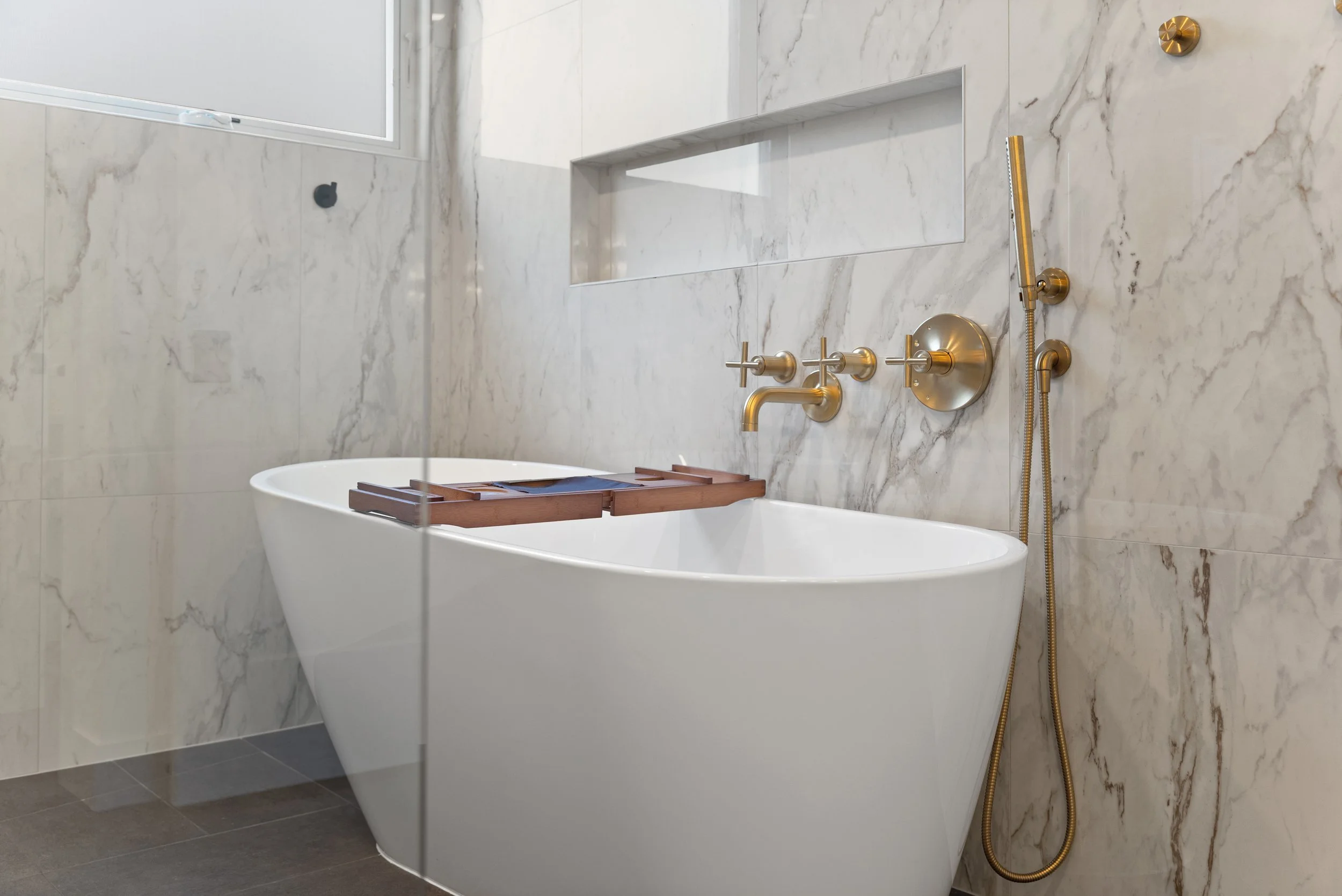 Freestanding soaking tub in remodeled master bathroom Fort Thomas Kentucky by Shade Tree Homes