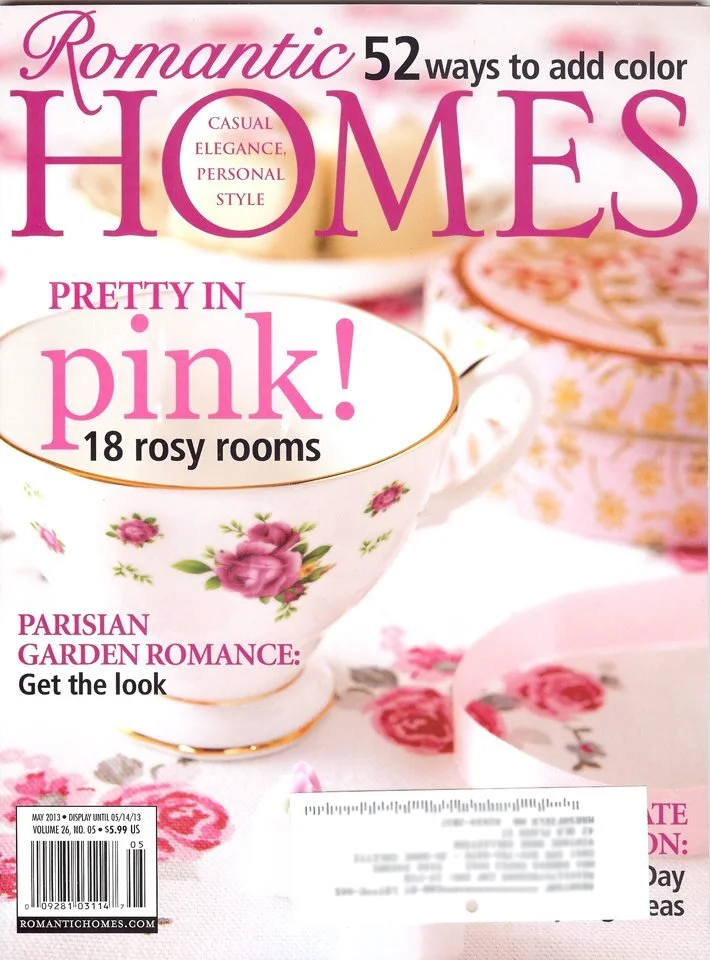 Artist and designer, Jo-Anne Coletti featured in A magazine cover titled "Romantic Homes" magazine featuring a pink floral teacup with a gold rim, surrounded by pink roses and floral patterns in the background.