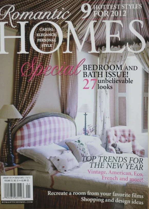 Cover of Romantic Homes magazine featuring a bedroom with pink and beige checkered upholstery, curtains, and a throw pillow. The magazine highlights romantic, vintage, American, eco, and French interior trends.