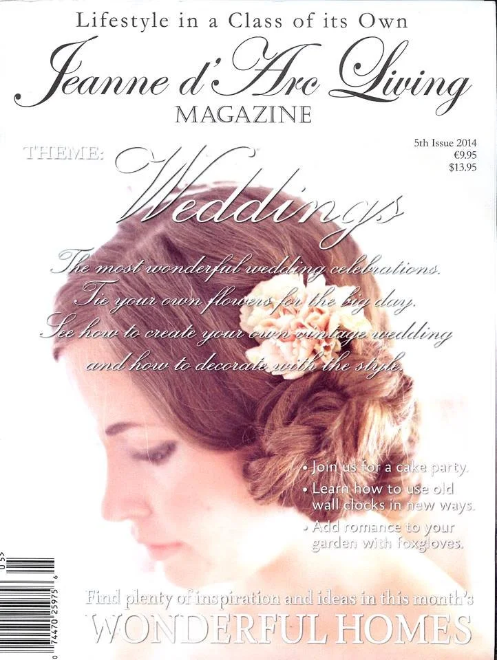 Cover of Jeanne d'Arc Living magazine 2014, featuring a woman with auburn hair adorned with peach-colored flowers, with the headline 'Weddings' and a subtitle about creating vintage wedding decorations.