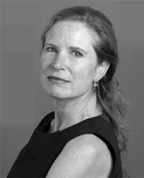 Black and white portrait of a woman with shoulder-length hair, looking serious.