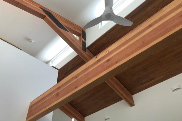 Heavy glulam beams and trusses support high south facing windows.