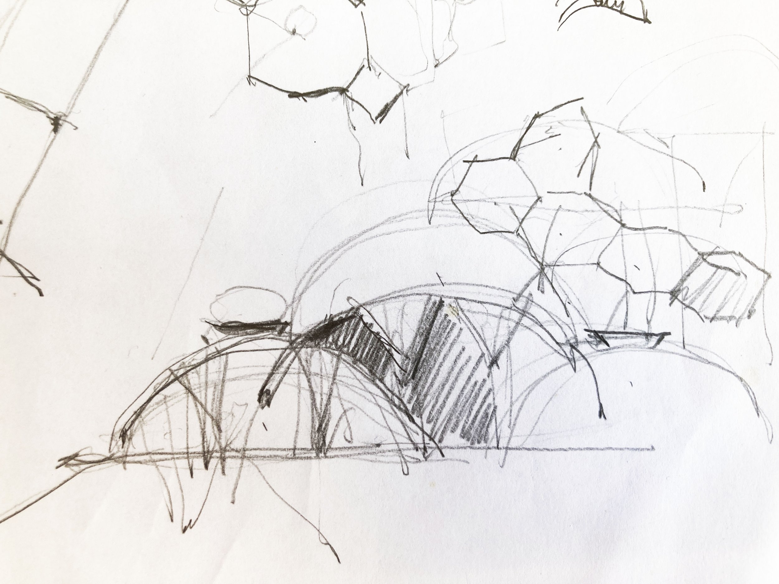 A rough sketch of various interconnected geometric shapes, like circles, arcs, and lines, drawn with a pencil.