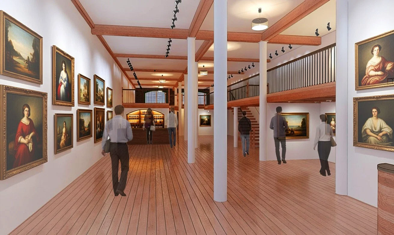 Interior of an art gallery with paintings on white walls, people viewing artwork, wooden floors, and a staircase on the right.