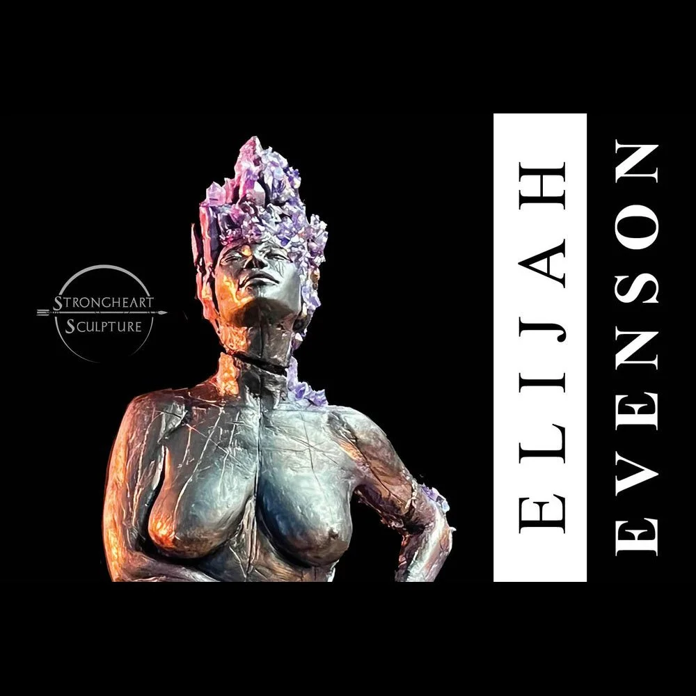 A sculpture of a woman with an elaborate headpiece, made of metallic material with purple accents, set against a black background. The sculpture is part of an exhibition by Strongheart Sculpture, featuring a logo with the words 'Strongheart Sculpture