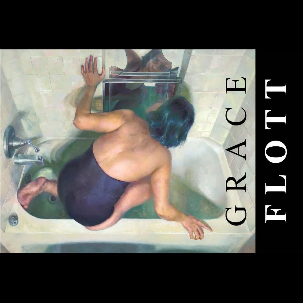 A person with shoulder-length dark hair crouches in a bathtub, wearing black. The person is leaning forward with one hand on the tub's edge and the other resting on the floor of the tub. The reflection of the person is visible in a mirror above the t