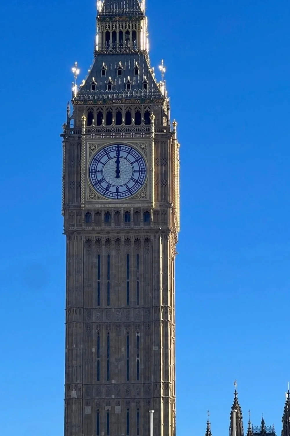 Close-up of Big Ben clock tower against a clear blue sky.