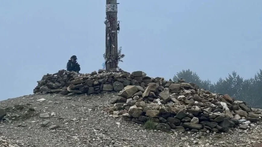 Camino Frances, Pilgrim Kneeling at Cruz de Ferro