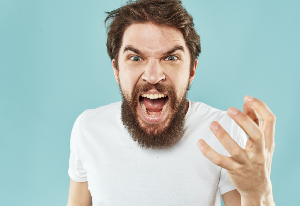 close up of bearded man screaming