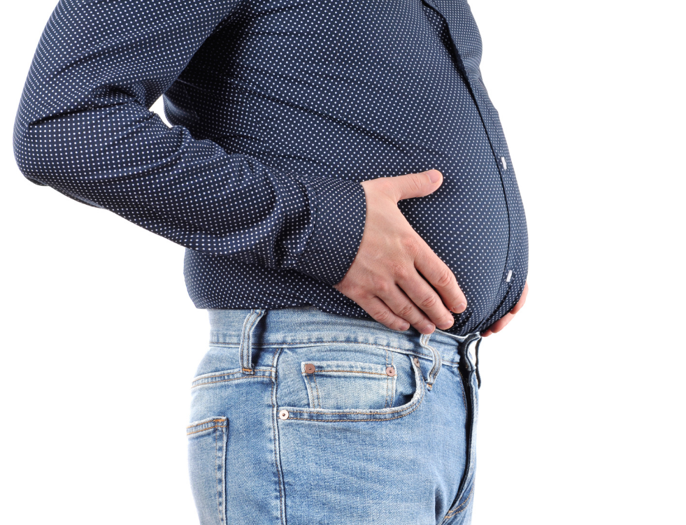 overweight man holding his stomach