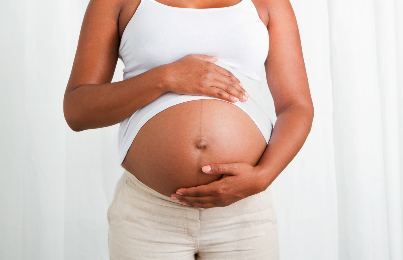 pregnant woman holding her belly