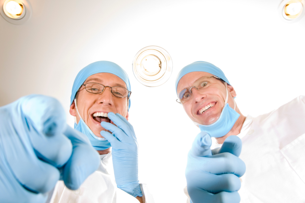 doctors pointing to the camera and laughing
