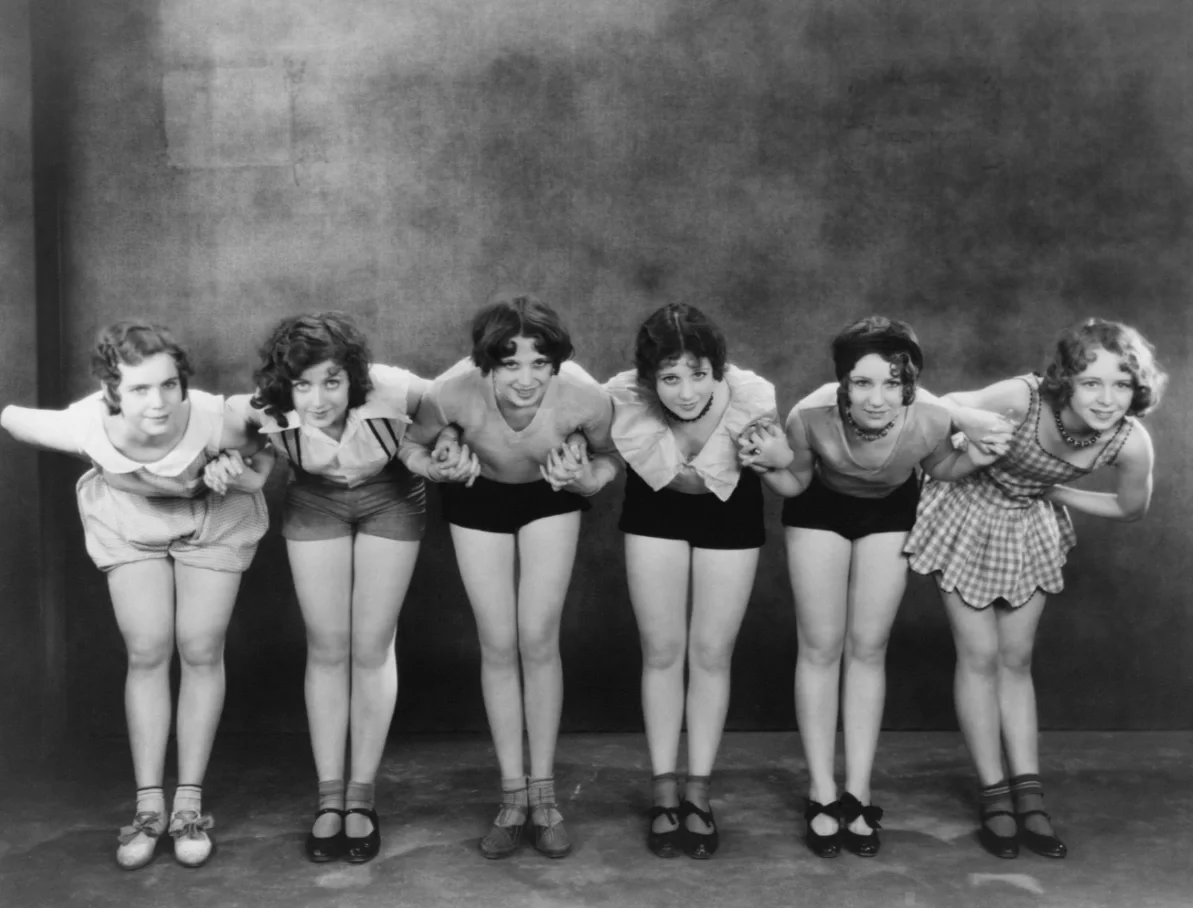 old time photo of women in a forward bend