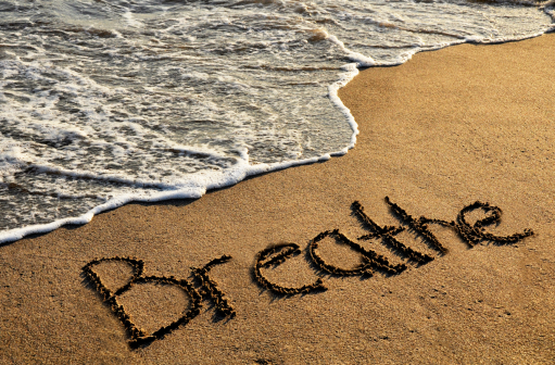 waves on shore with the word "breathe" written in it