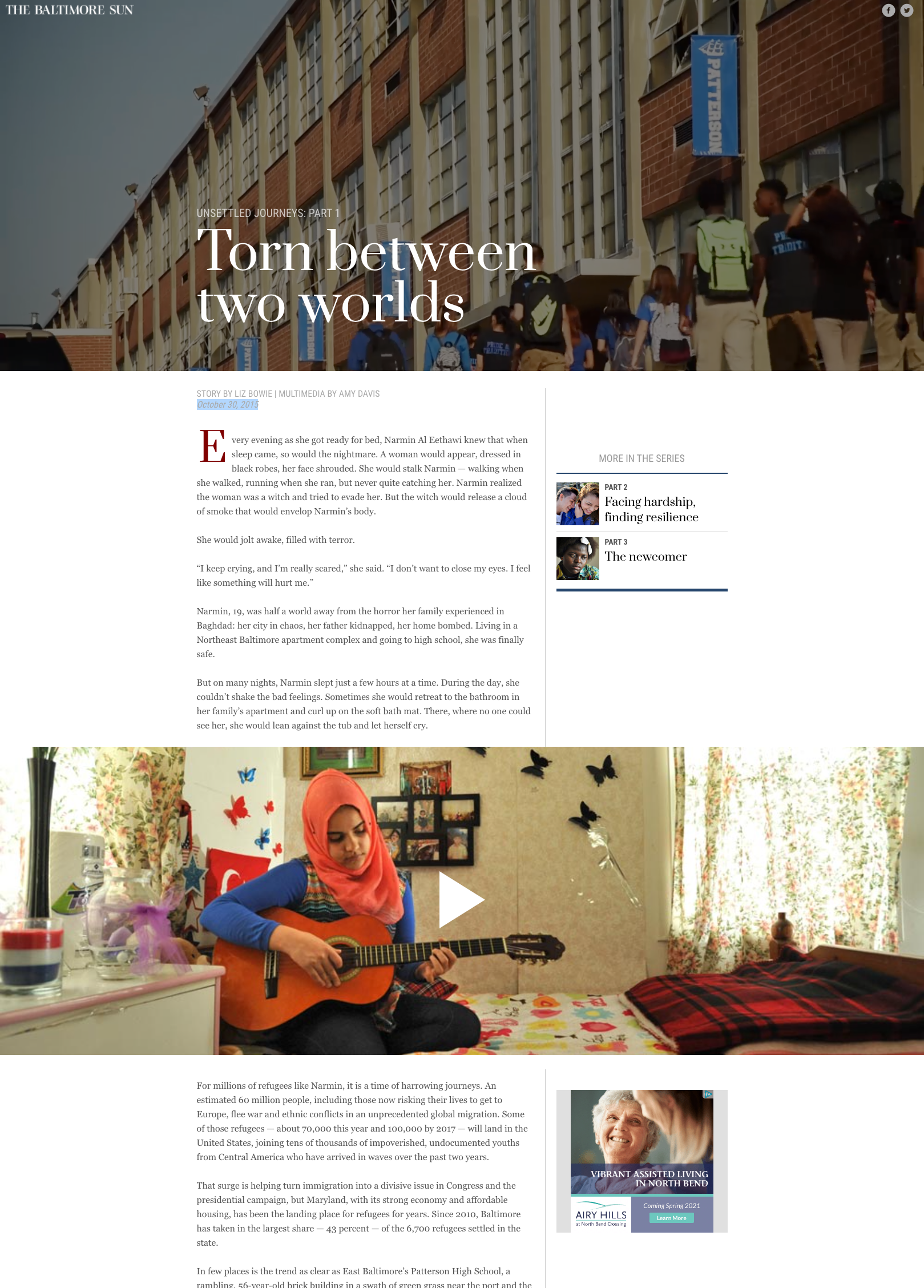 A young woman wearing a red hijab and blue long sleeve shirt playing a guitar in a cozy room with floral curtains and butterfly decorations on the wall.