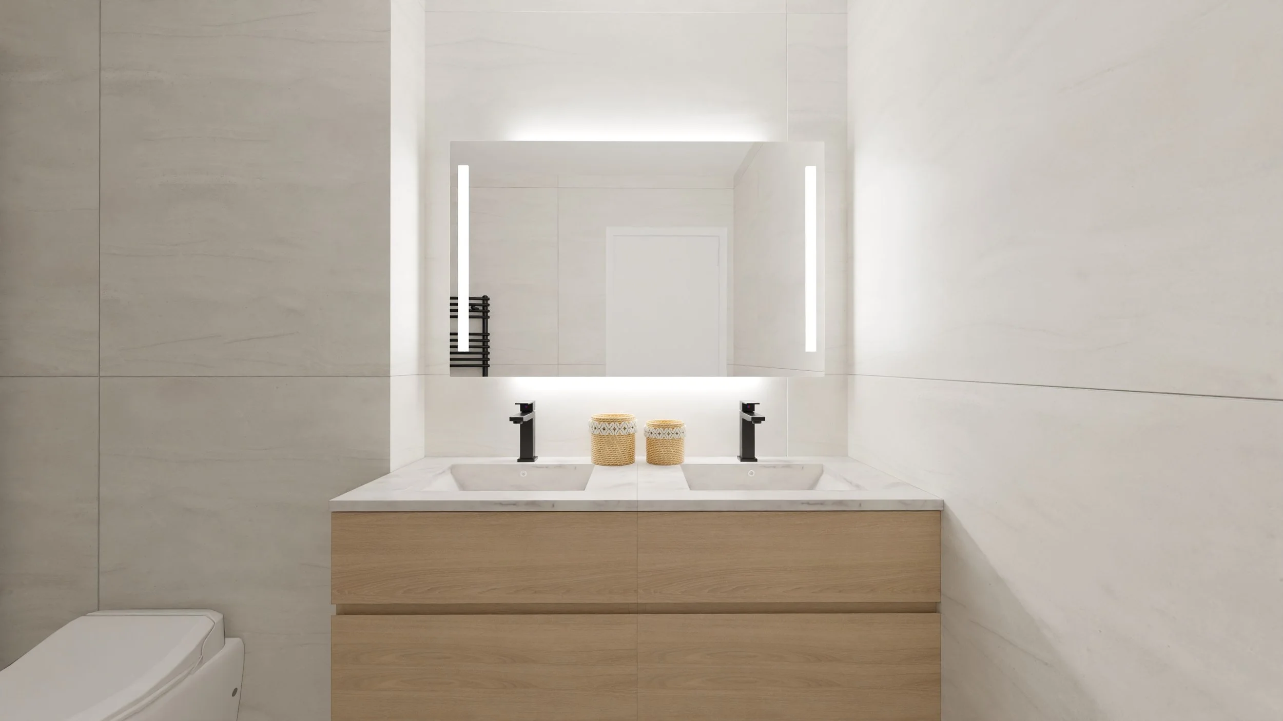 Rénovation haut de gamme d'un appartement à Valdahon avec salle de bain avec miroir rectangulaire au-dessus d'un lavabo double avec deux robinets noirs, deux paniers en osier sur le comptoir, et des murs en carrelage blanc. Agencement sur mesures