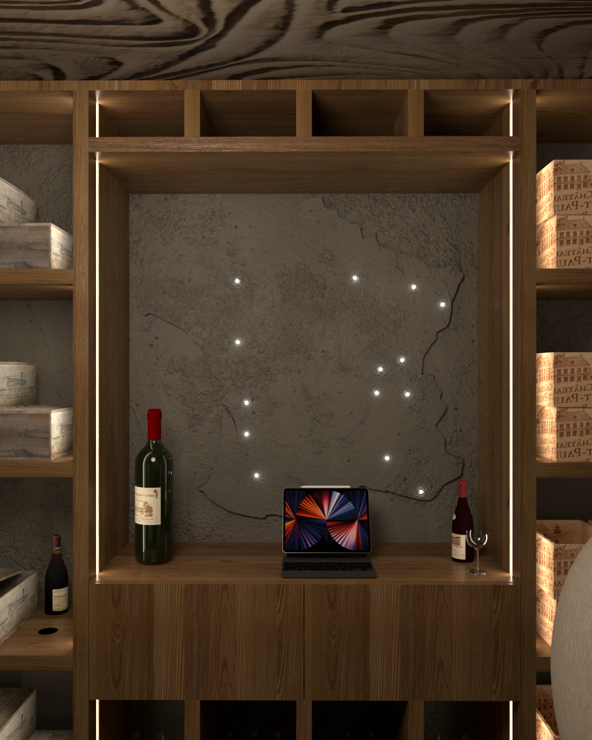 Une petite cave à vin avec deux fauteuils, une table en bois, des étagères remplies de caisses de vin, une carte de la France. Appartement haut de gamme rénové selon le thème du vin à Neuilly sur Seine.