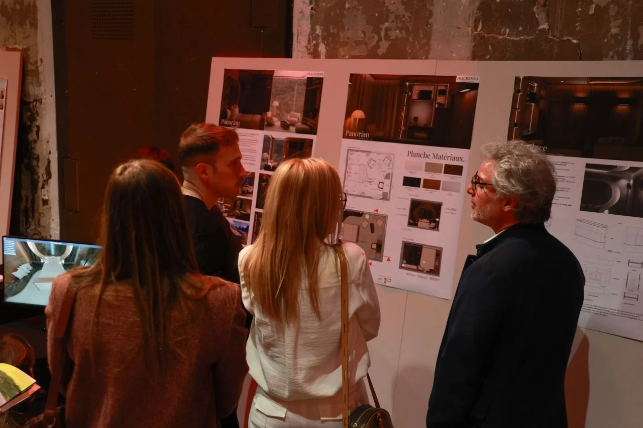 Groupe de personnes regardant une affiche de présentation d'architecture ou de design intérieur dans une salle d'exposition ou une conférence.