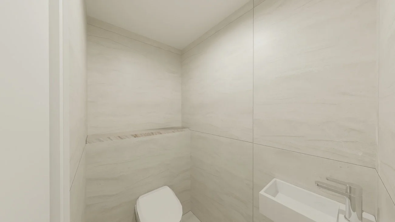 Rénovation haut de gamme d'un appartement à Valdahon avec WC minimaliste avec murs en marbre clair, une petite banquette en marbre et un lavabo en béton. Agencement sur mesures