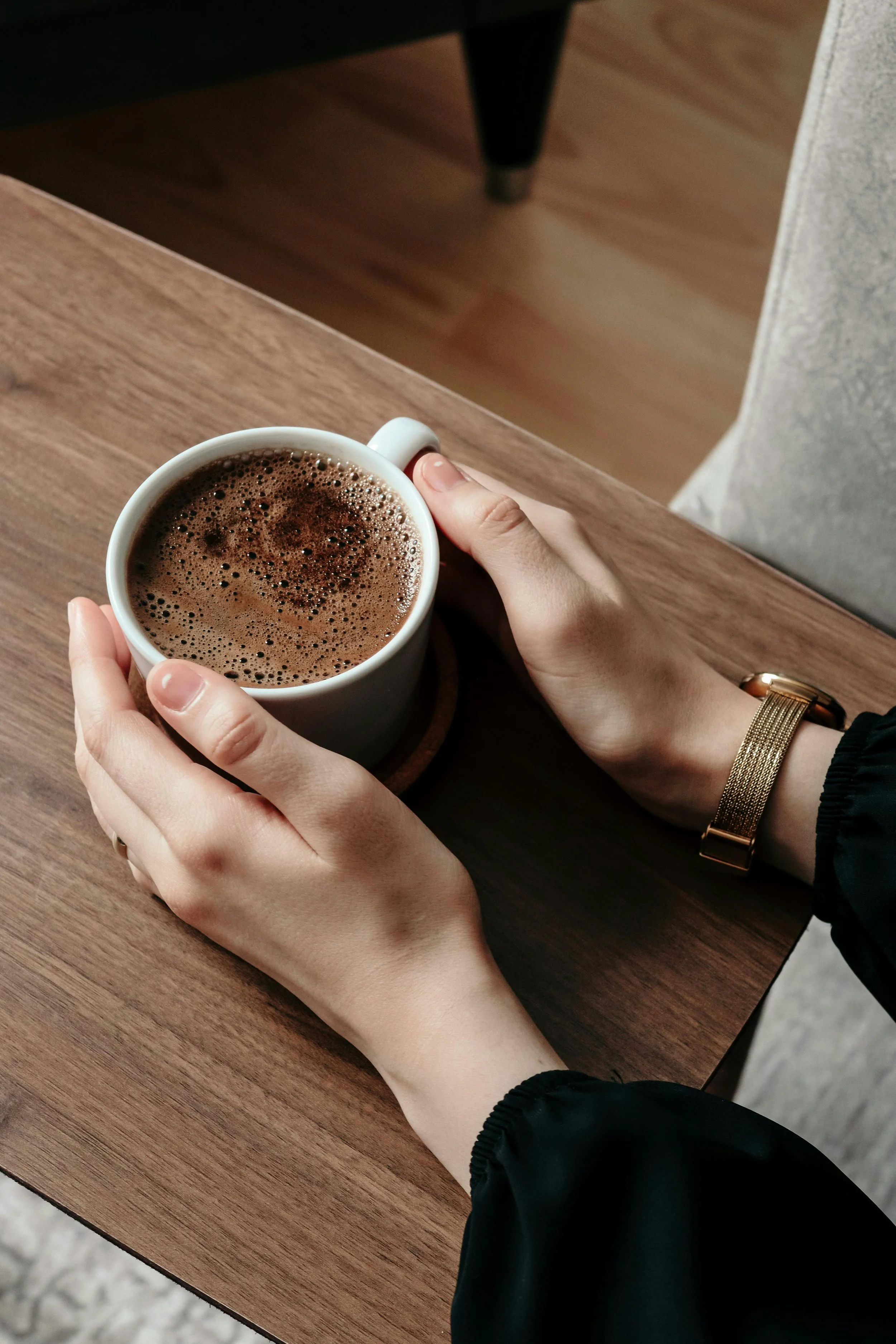 Close-up of hands holding a warm mug, representing the restful, deeply supportive space provided for burnt-out therapists and helping professionals at Made Whole Counseling.