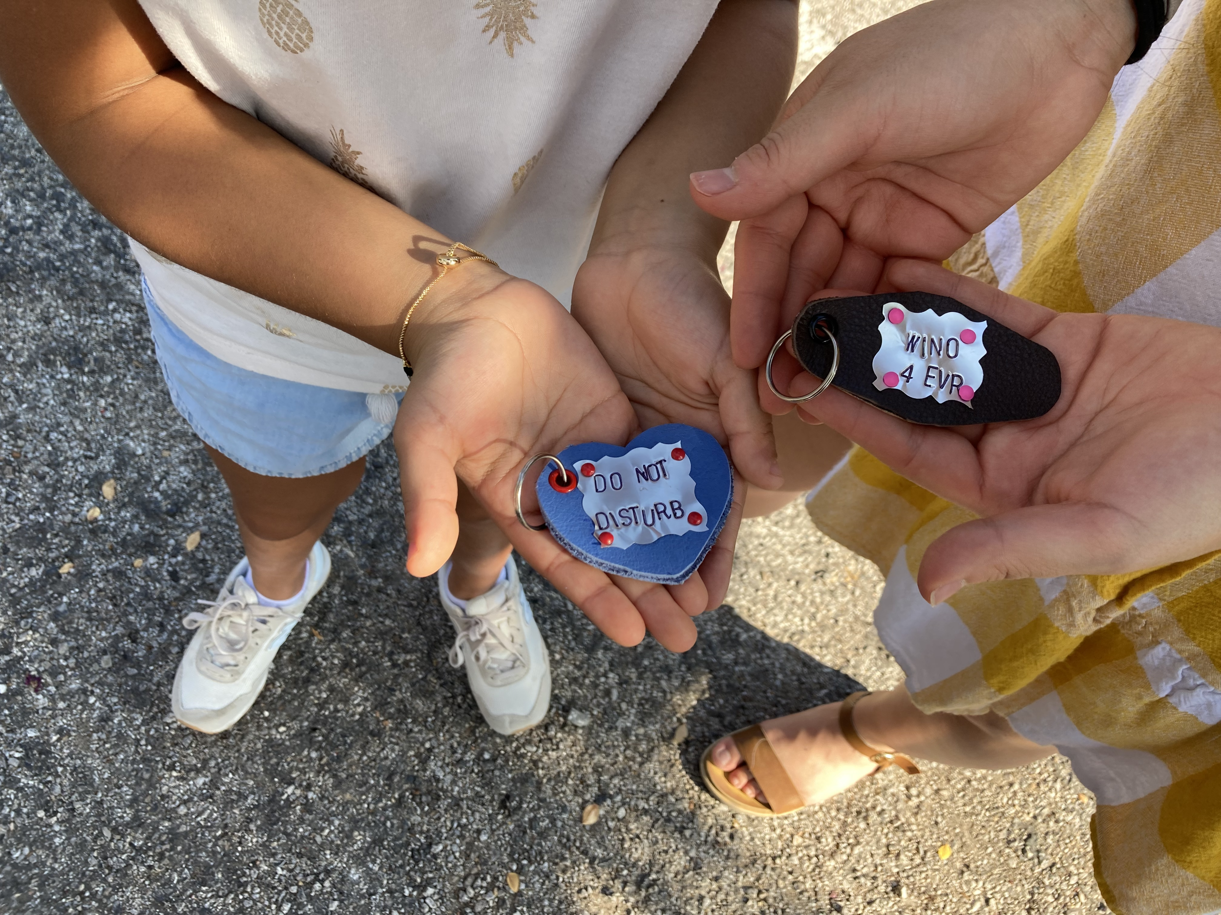Personalized leather keychains made from recycled materials at a Kiki Knows Art workshop.