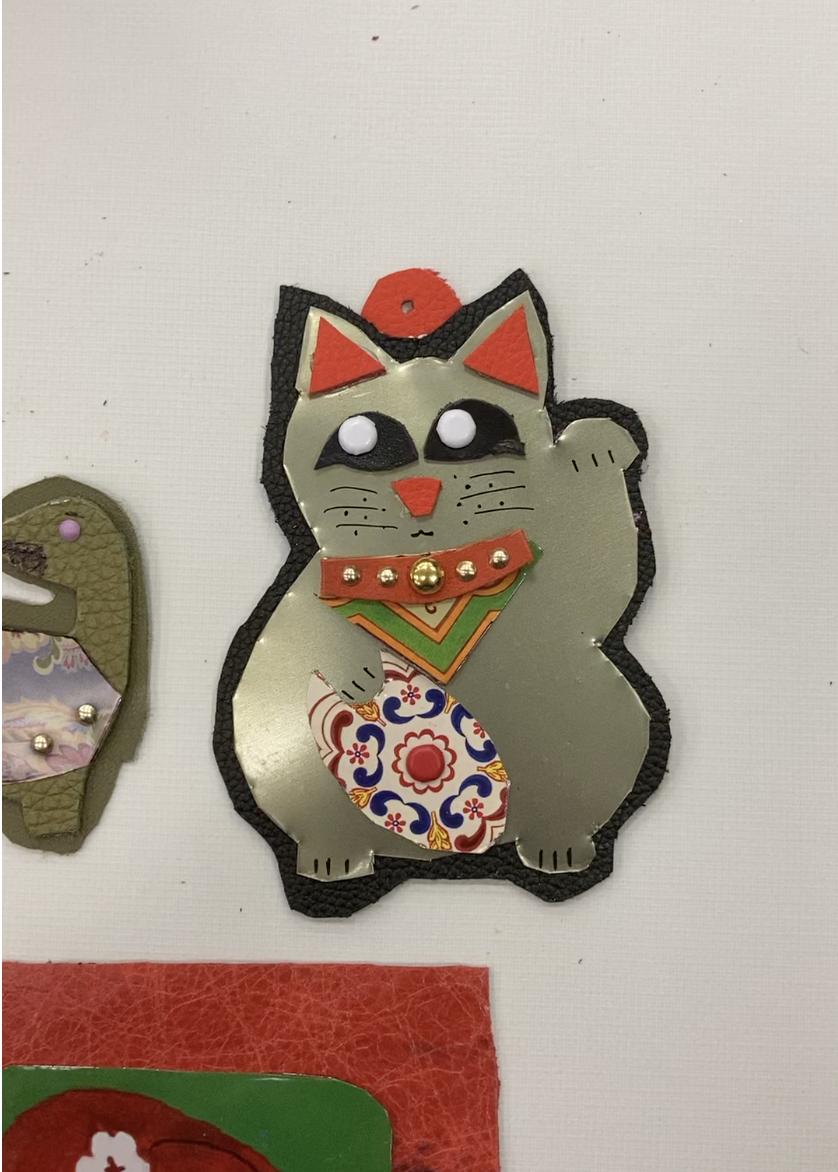 Colorful upcycled cat ornament made at a Kiki Knows Art workshop in Dallas.