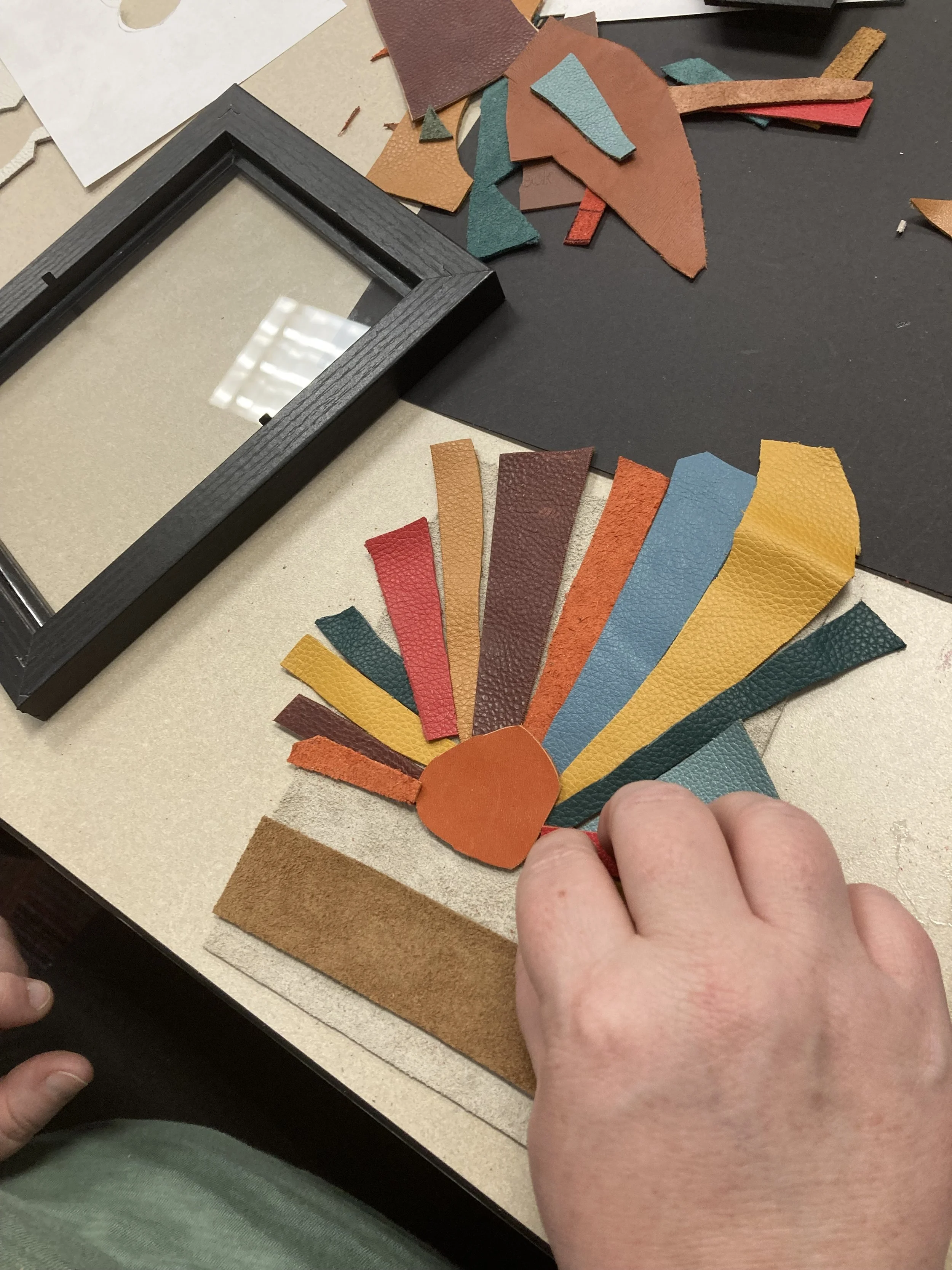 Leather art in progress of multi colored sun rays at a Kiki Knows Art workshop.