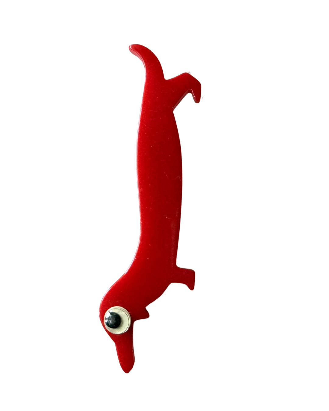 Red toy dog with a large eye on its head.