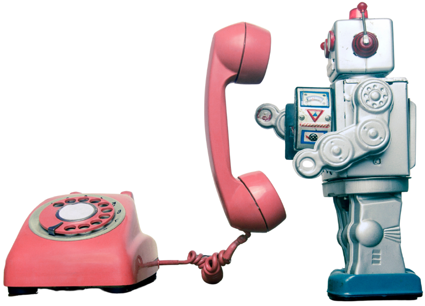 A vintage pink rotary telephone connected to a robot holding the receiver to its ear.
