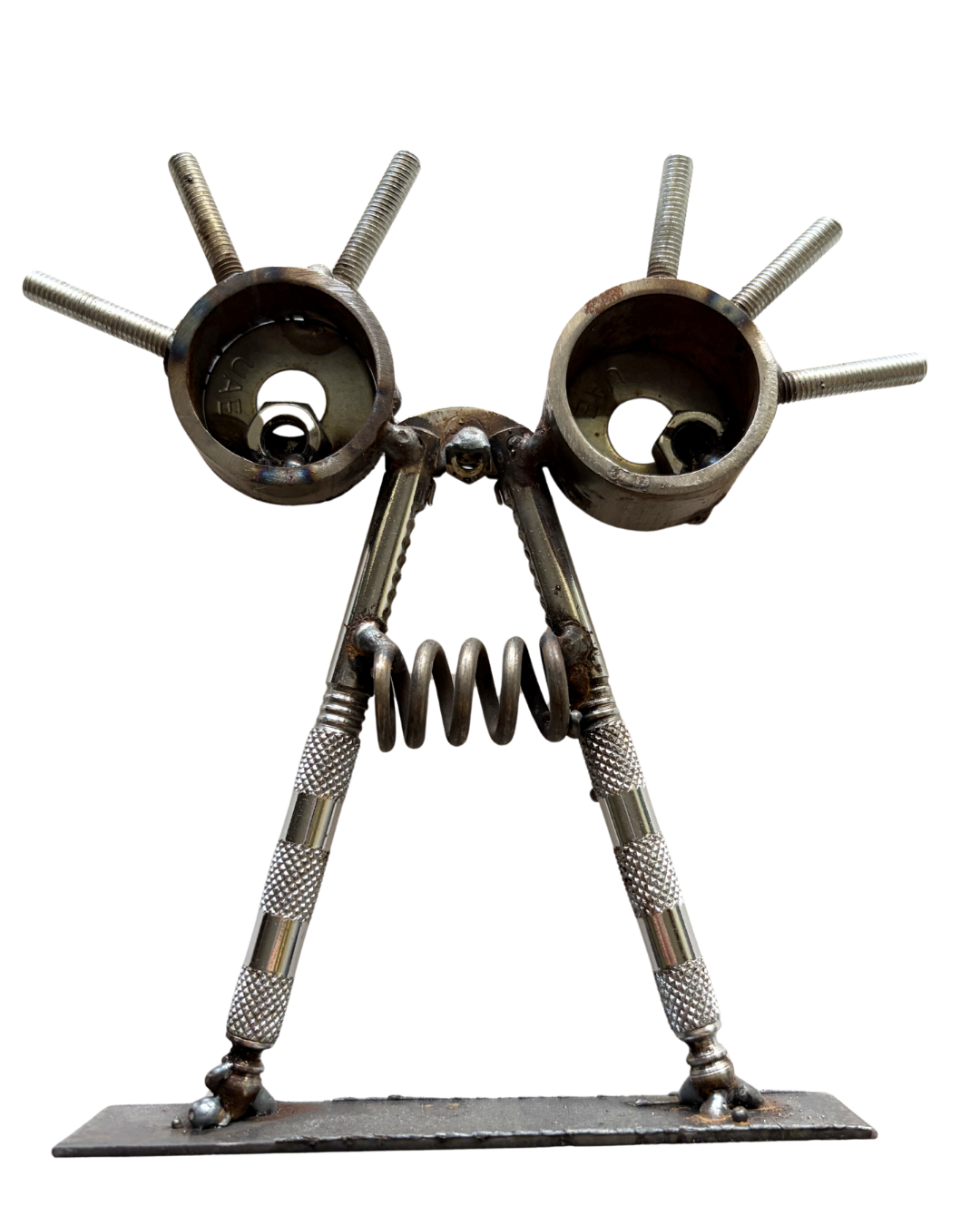 Sculpture of an robot made from metal parts, including bolts, springs, and other hardware, with large circular eyes and a textured body.
