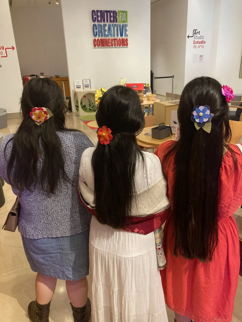 Three women wearing floral hair accessories