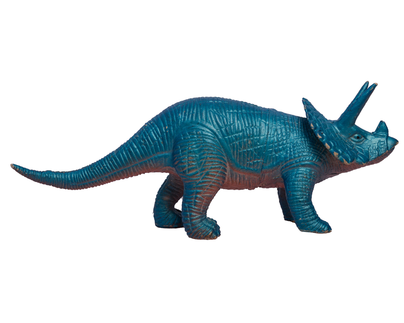 Toy model of a blue rhinoceros with a textured surface, standing on four legs, with a horn on its nose and other small horns on its head.