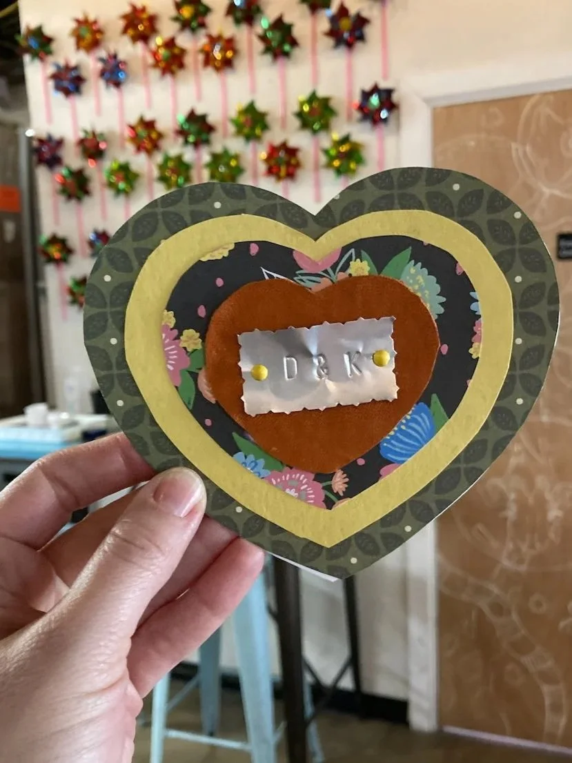 Valentine's day art with stamped initials made at a Kiki Knows Art workshop.