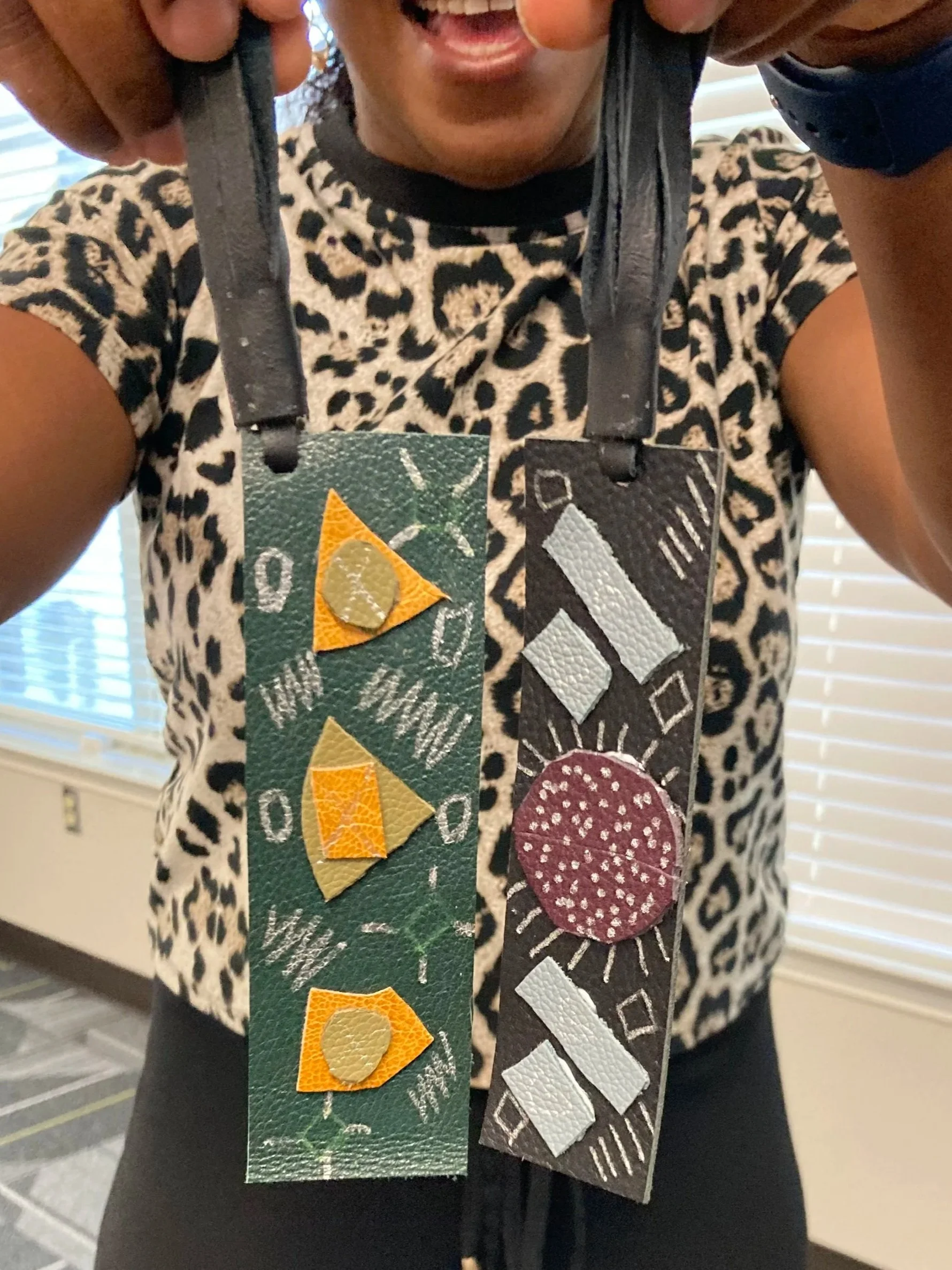 Leather keychains with abstract shapes made at a Kiki Knows Art workshop.