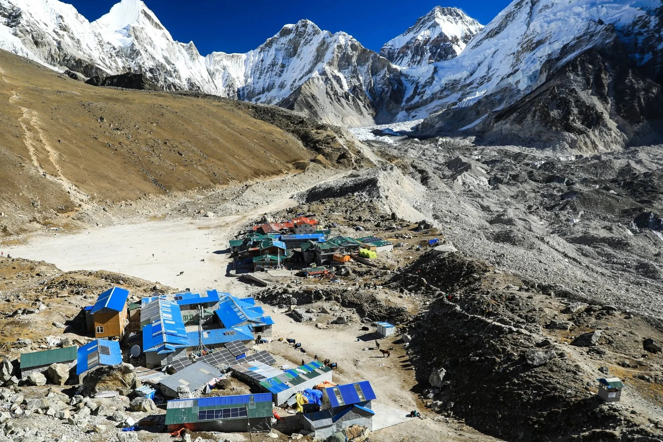 Mountain landscape featuring a base camp, used to represent the 'Base Camp Audit' service, where we assess your current executive function and establish a foundation for change.