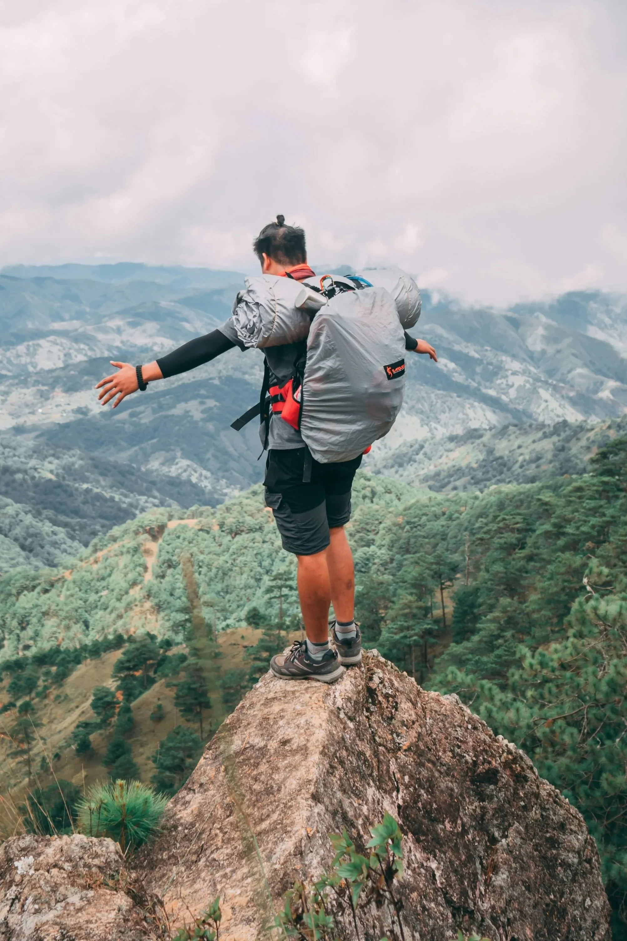 A hiker standing on a mountain ridge, symbolizing the 'Ridge Expedition' package—our premium, intensive program for achieving sustainable success and peak performance.