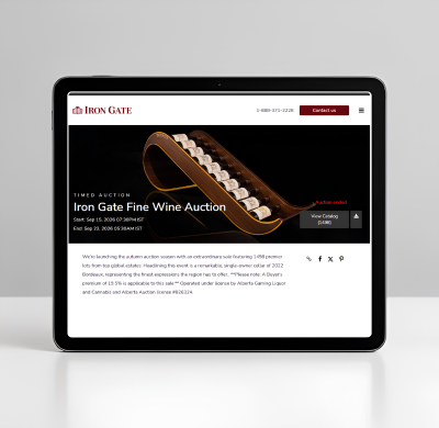 Tablet displaying the Iron Gate Fine Wine Auction website with a wine bottle graphic and auction details