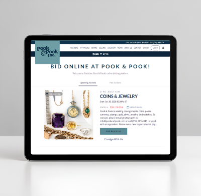 Tablet displaying a Pook & Pook online auction webpage featuring coins and jewelry.