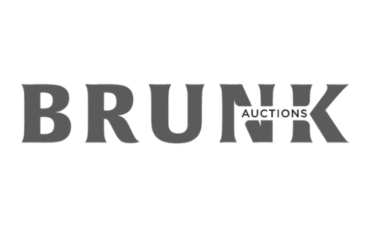 Brunk Auctions logo in dark gray on a black background