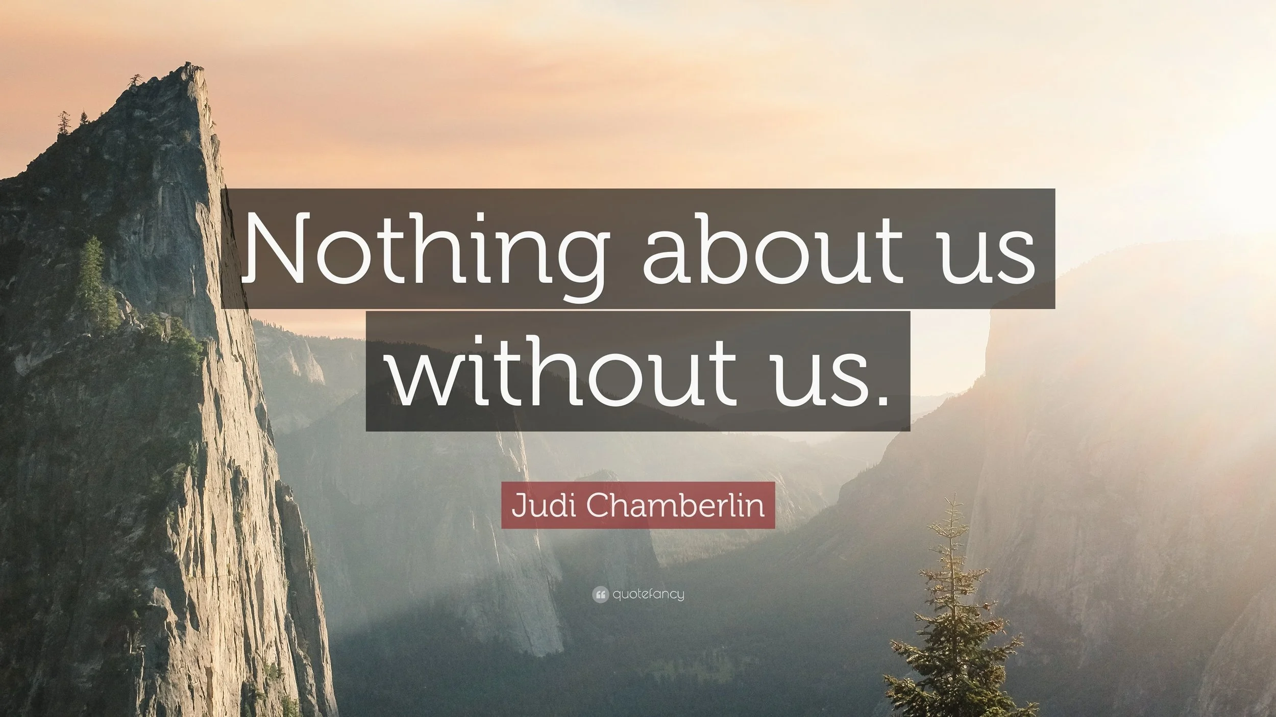 A mountain landscape with cliffs and trees at sunrise or sunset, with a quote overlaid that reads 'Nothing about us without us.' by Judi Chamberlin.
