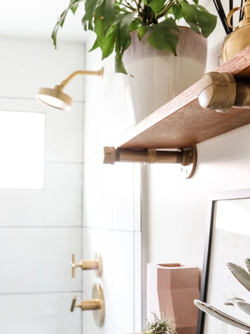 Swipe to see where we started ➡️
This bathroom was clean - but very builder-basic. The banded tile detail, heavy grout lines, and mismatched finishes kept the space from ever feeling cohesive or elevated.
So we stripped it back and rebuilt it with in